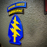 Special Forces display insignia featuring Airborne tab and arrowhead emblem with yellow dagger and lightning bolts.