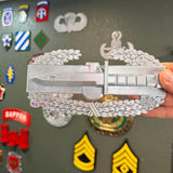 Combat Action Badge display insignia with bayonet and oak wreath held in hand, showcasing its detailed design.