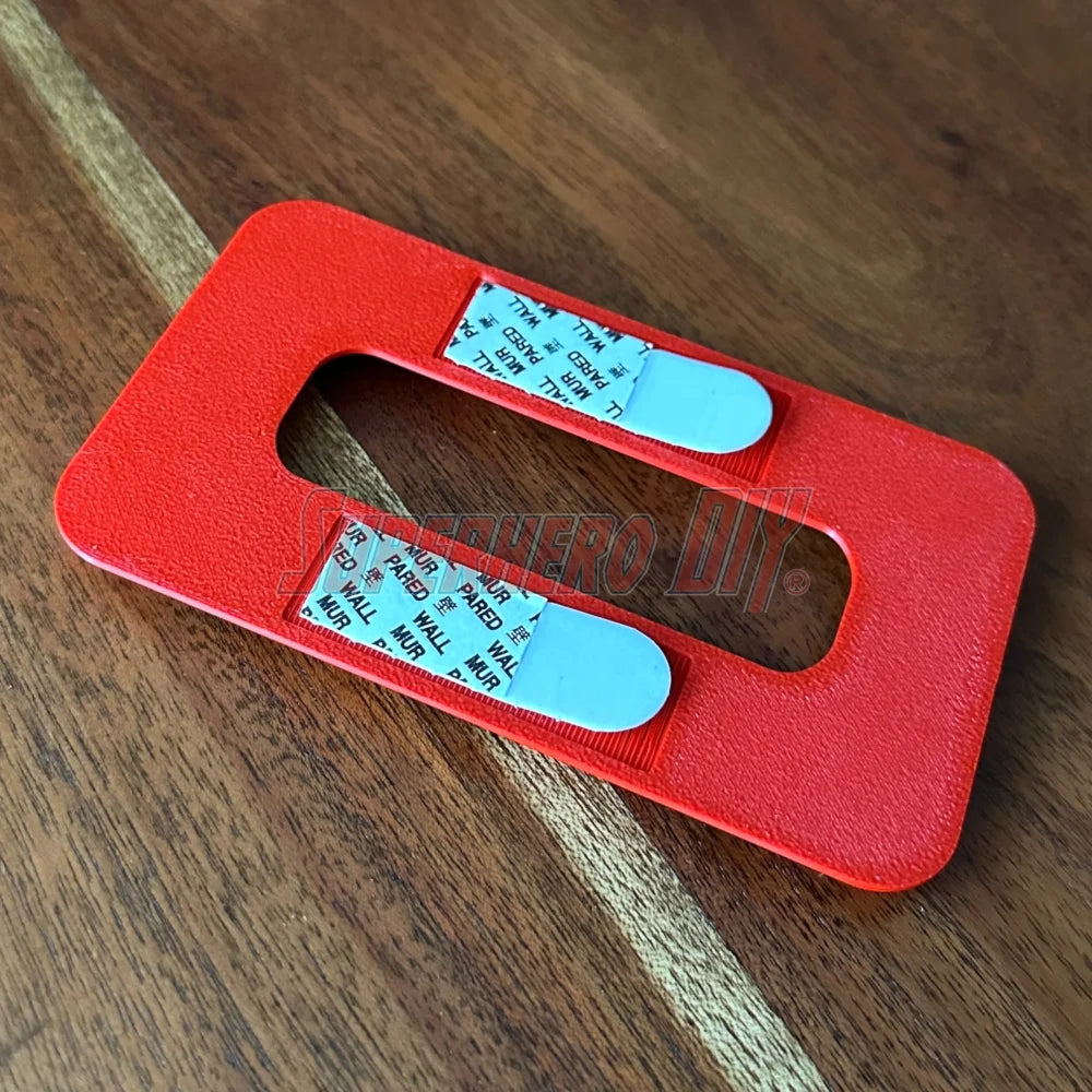 Close-up of magnetic Tech Deck wall mount with embedded magnets and Command Strip backing