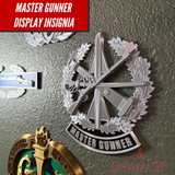 Master Gunner Badge display insignia showcased on a wall, highlighting the detailed 3D design.
