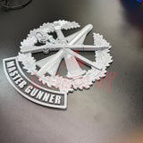 3D Master Gunner Badge display insignia on a dark surface, showcasing military arms and the title 'MASTER GUNNER'.