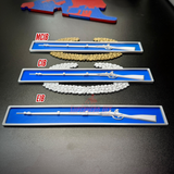 Expert Infantryman Badge (EIB), Combat Infantryman Badge (CIB), and Master Combat Infantryman Badge (MCIB) display
