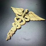 Army Medical Corps caduceus wall display in gold with winged staff and twin serpents, perfect for home decor.