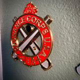 Ordnance Regimental Crest displayed on a wall, showcasing red and gold colors of the Ordnance Corps USA.