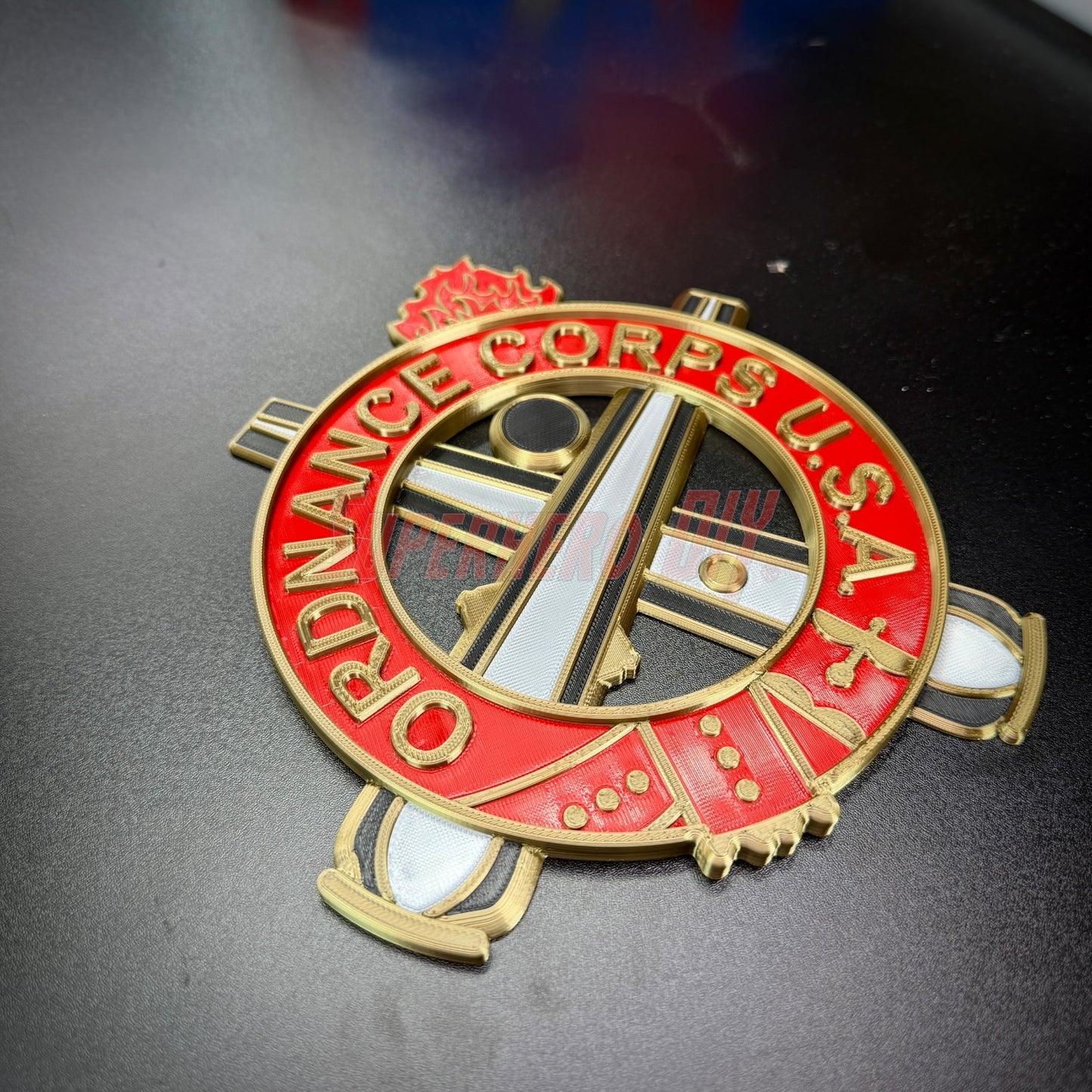 Ordnance Regimental Crest displayed in gold and red, symbolizing the Ordnance Corps U.S.A.