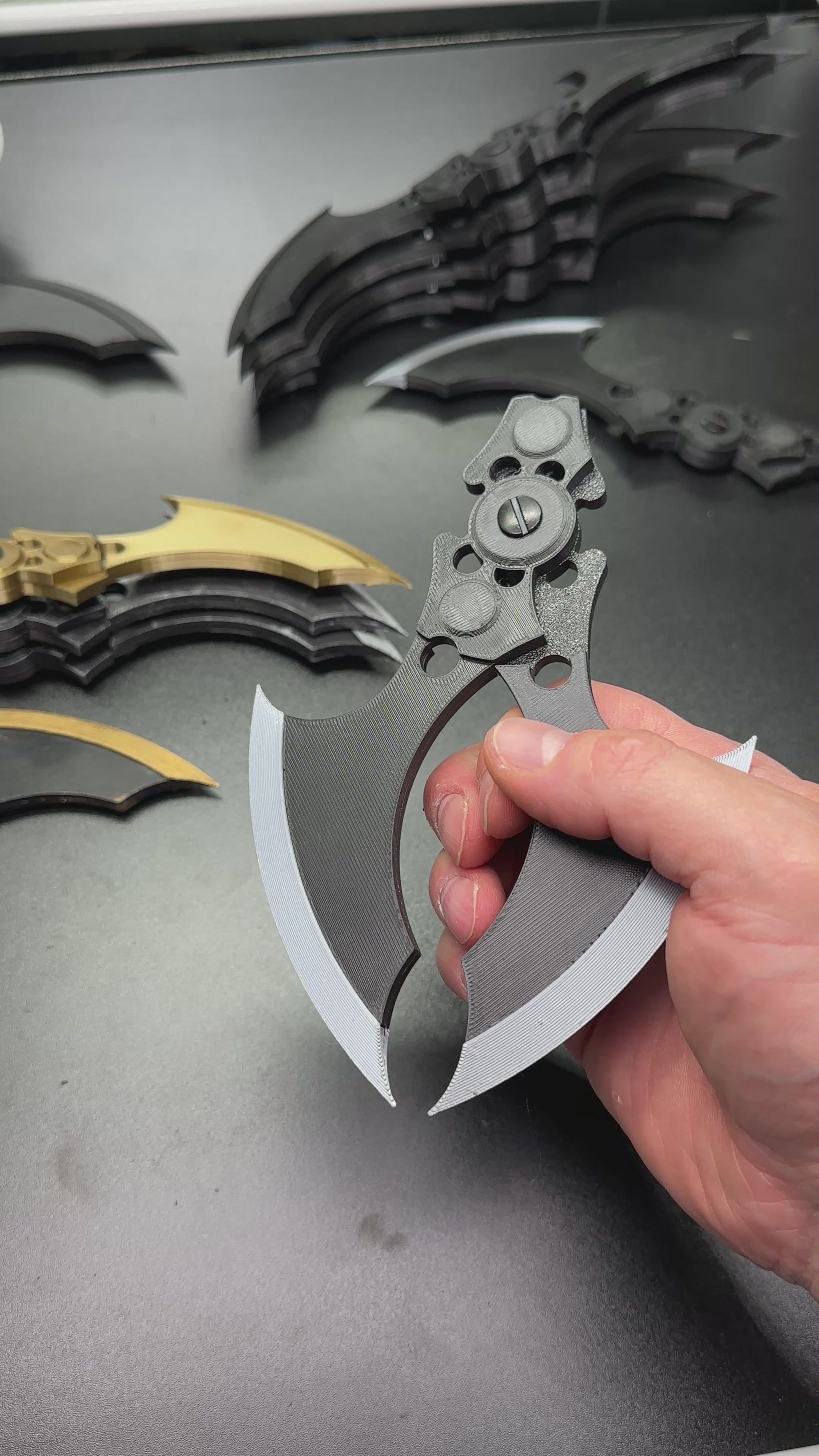 Hand holding MAGNETIC Folding Arkham Batarang Cosplay Prop - 10" version with neodymium magnets in a closed position.