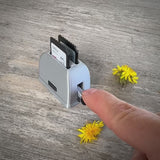 Mini toaster-shaped SD card holder that stores 2 memory cards and doubles as a fun desktop fidget
