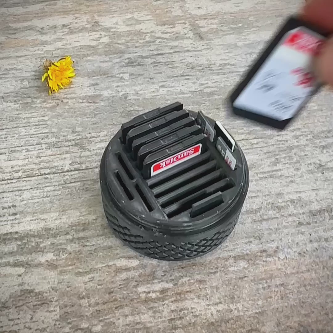 Durable SD card travel case with tire tread design, provides rugged protection and organized storage for memory cards while traveling