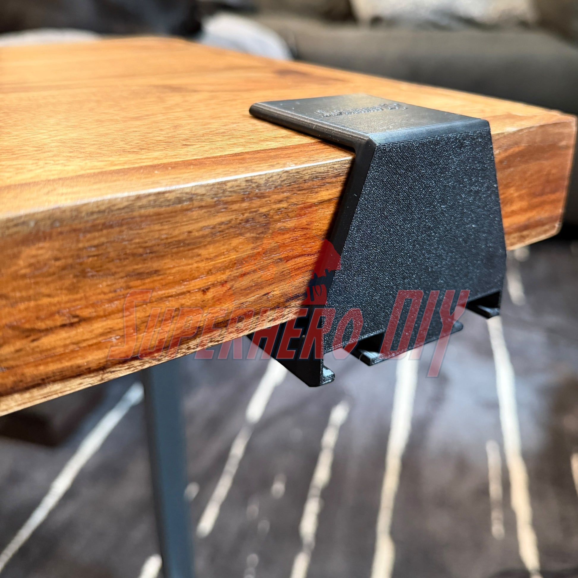 Under-desk PS5 controller mount attached to a wooden table edge for efficient storage.