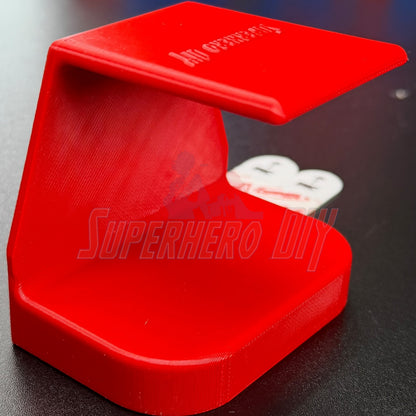 Under-desk PS5 controller mount in red color, designed to store and charge PS5 controllers without drilling.