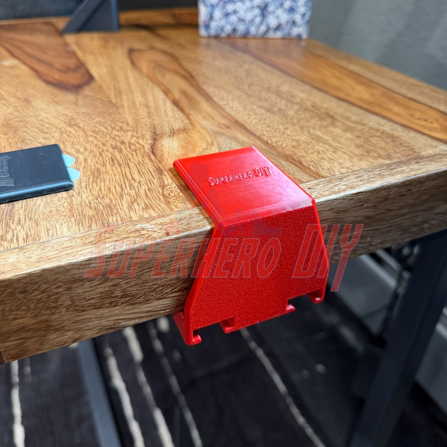 Under-desk PS5 controller mount securely attached to a desk, designed to hold and charge PS5 controllers.