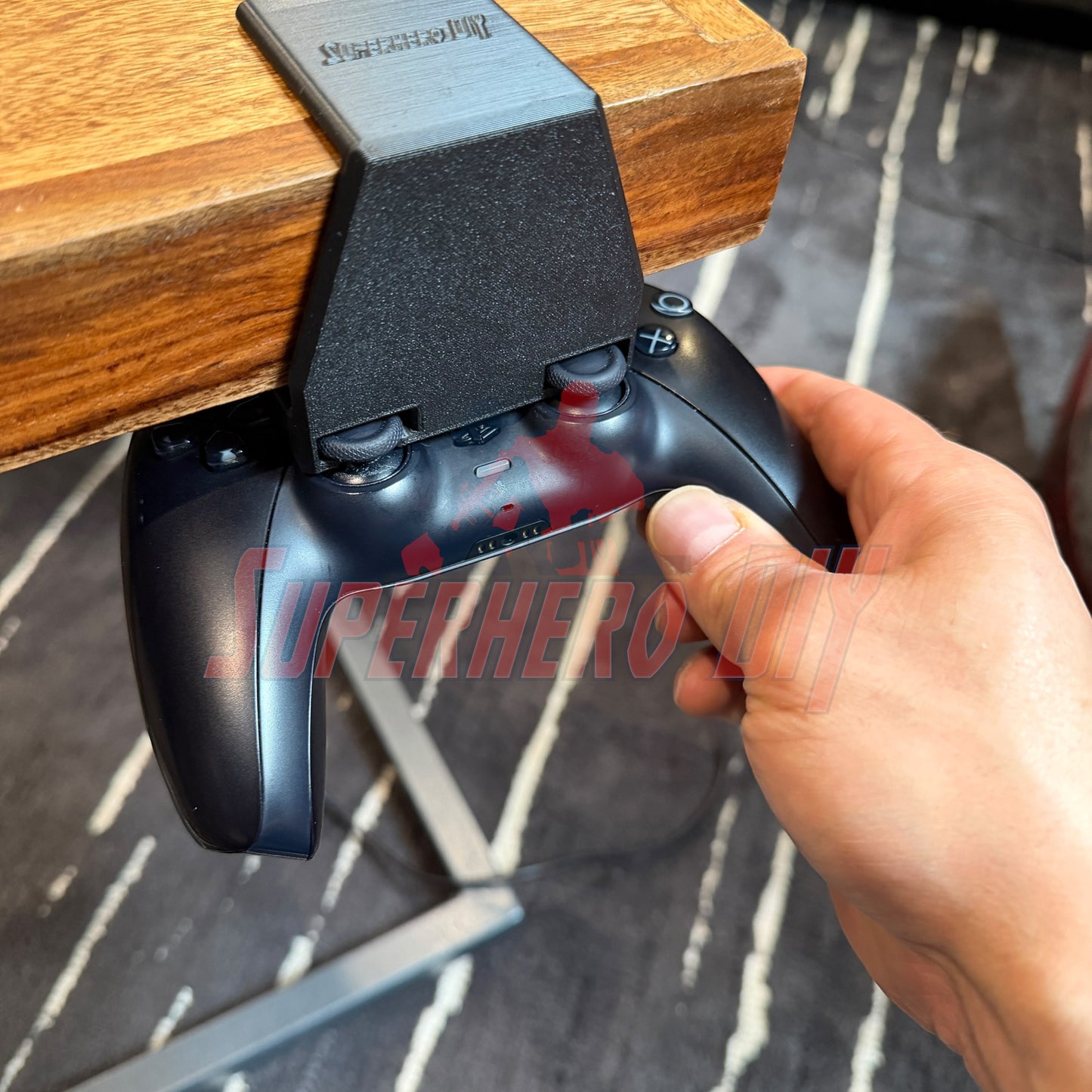 Under-desk PS5 controller mount holding a controller under a desk for convenient storage.