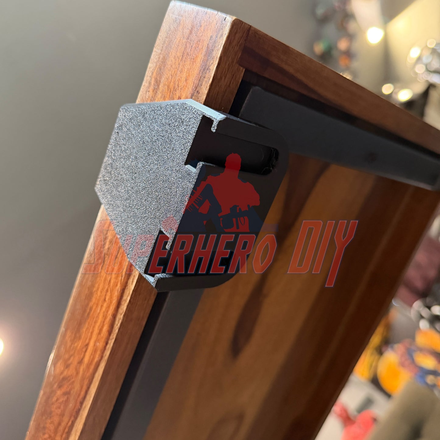 Close-up view of under-desk PS5 controller mount securely attached to a wooden desk surface.