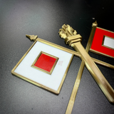 Detailed view of Army Signal Corps insignia featuring crossed signal flags and a flaming torch.