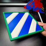 3rd Infantry Division display insignia featuring blue and white stripes, held by a hand, showcasing detailed 3D printing.