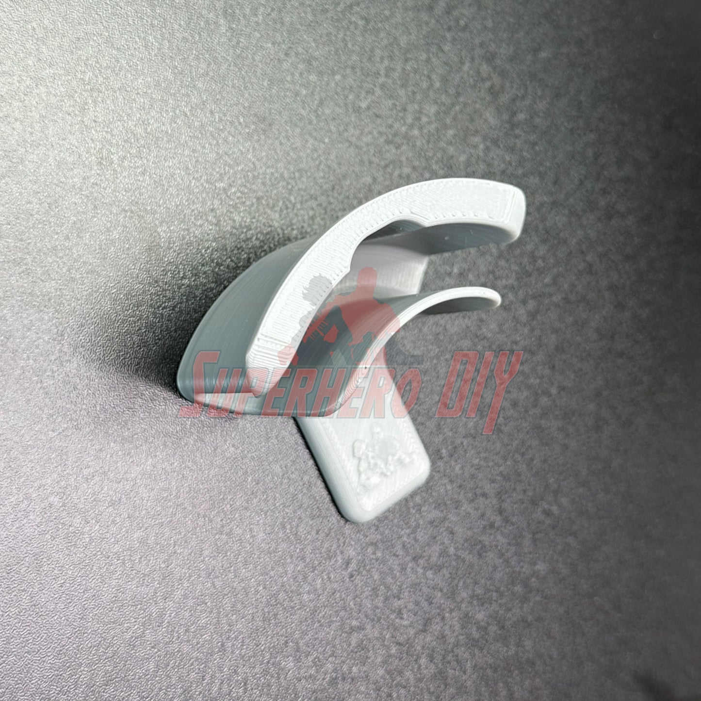 Hat display wall mount shown on a grey surface for organizing and displaying hat collection with ease.