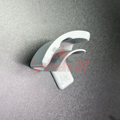 Hat display wall mount shown on a grey surface for organizing and displaying hat collection with ease.