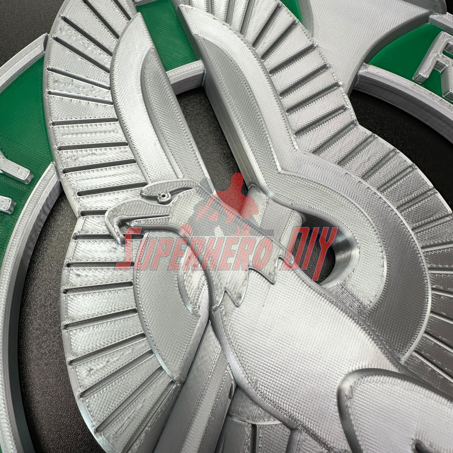 Detailed Army recruiter badge insignia in silver with green accents, featuring eagle, torch, and stars prominently displayed.