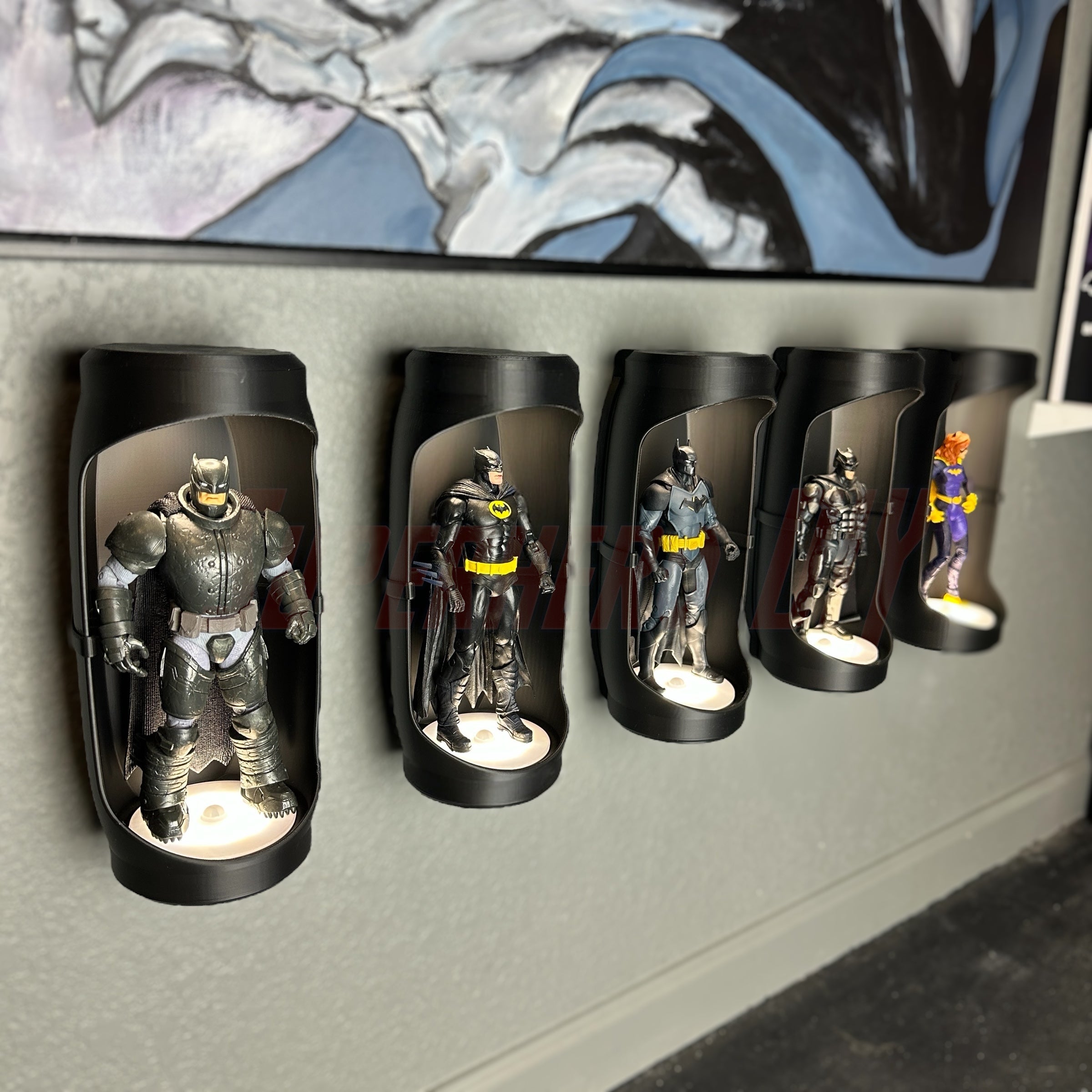 Set of superhero action figure display pods mounted on a wall