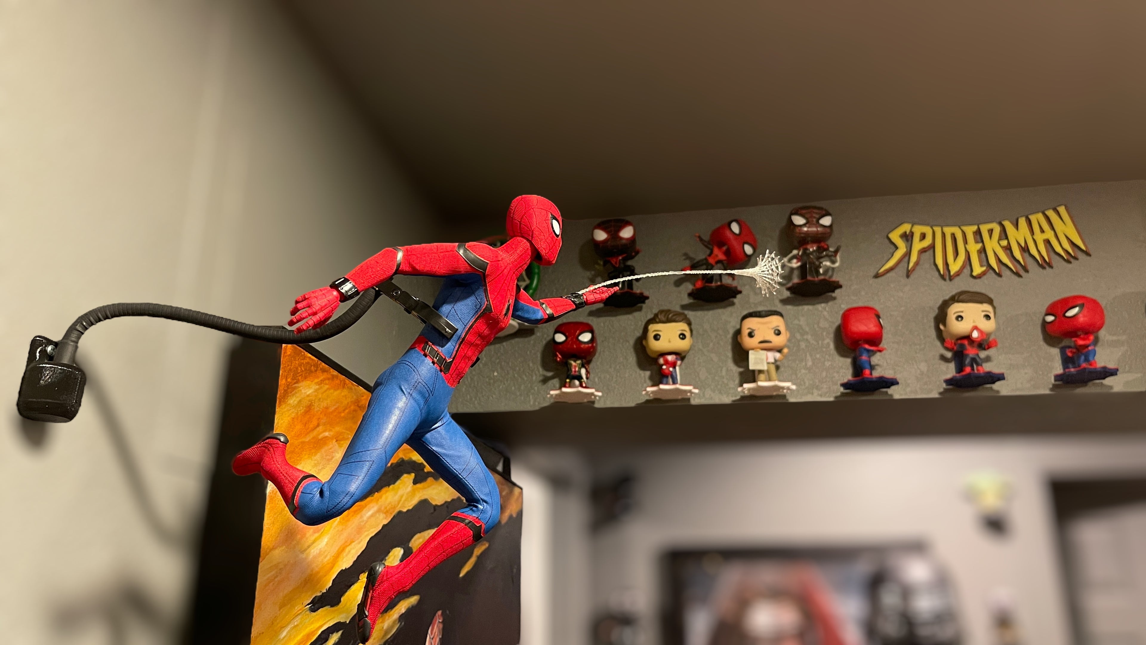 superhero hot toys wall mount and funko pops mounted on the wall