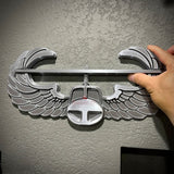 Air Assault Badge display showing shiny silver finish and detailed wings being mounted on a wall.