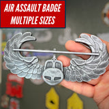 Subdued air assault badge display, showcasing its wings and multiple size options for military insignia.