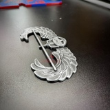 Subdued air assault badge display insignia on a black surface, showcasing hand-painted details.