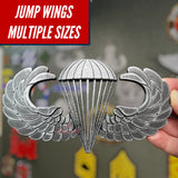 Subdued airborne jump wings replica with multiple sizes displayed in a veteran memorabilia collection.