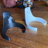 Black and white baseball display holders side by side on a wood table