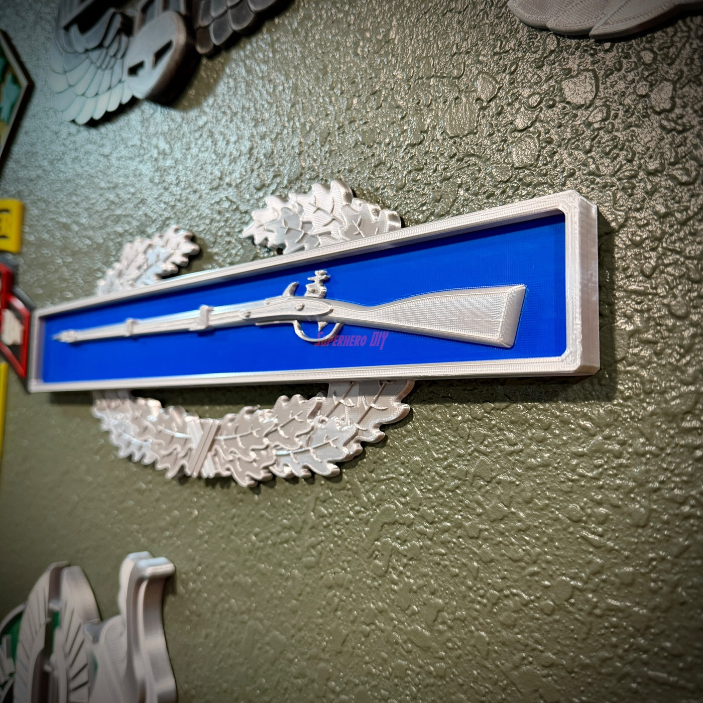 Infantryman Badge Replica Display with 1795 Springfield musket on infantry-blue bar featuring combat infantryman badge.