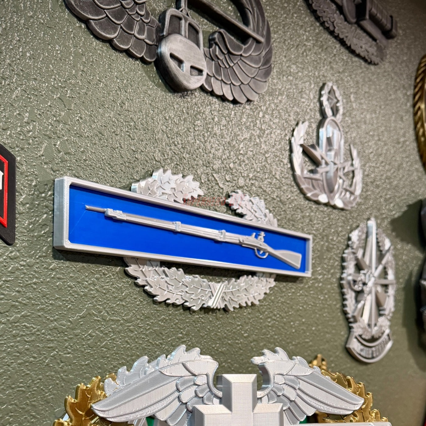 Infantryman Badge replica display with 1795 Springfield musket on blue bar and oak wreath.