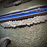 Close-up view of Infantryman Badge replica with infantry-blue bar and detailed oak wreath, showcasing the combat infantryman badge.