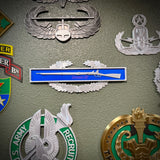 Infantryman Badge replica display featuring 1795 Springfield musket and badges including combat infantryman badge.