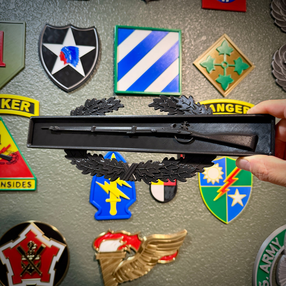 Combat Infantryman Badge display with 1795 Springfield musket and oak wreath, showcasing military insignia.
