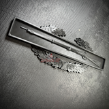 Combat Infantryman Badge display featuring a musket on an oak wreath, emphasizing military insignia.