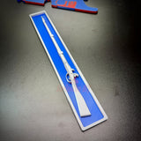 3D-printed Expert Infantryman Badge replica with a white rifle design on a blue background.