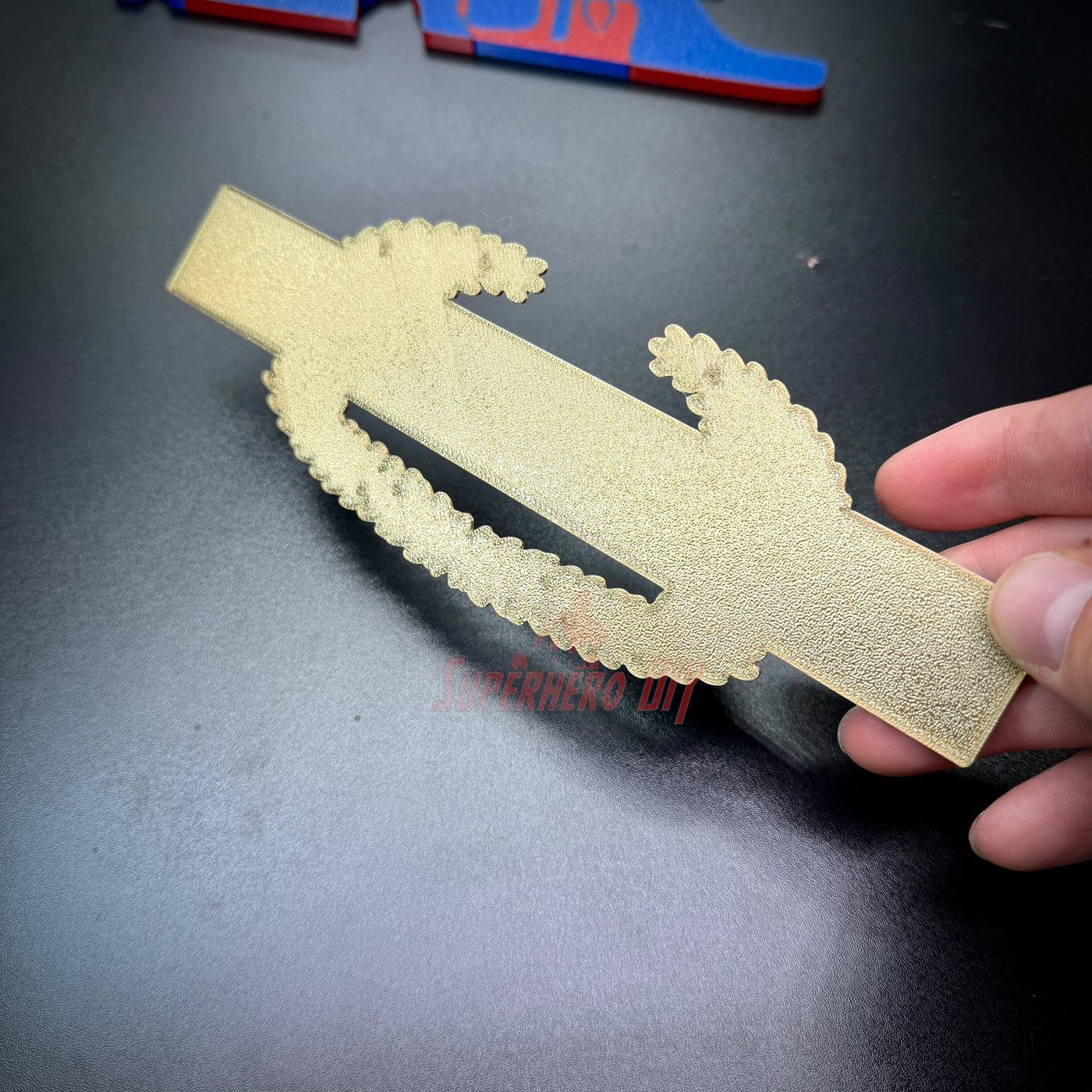 Master Combat Infantryman Badge replica in hand, showcasing intricate design and detail.