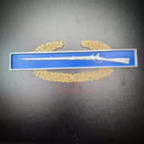 Master Combat Infantryman Badge 3D-printed replica displayed with a rifle in a presentation case.