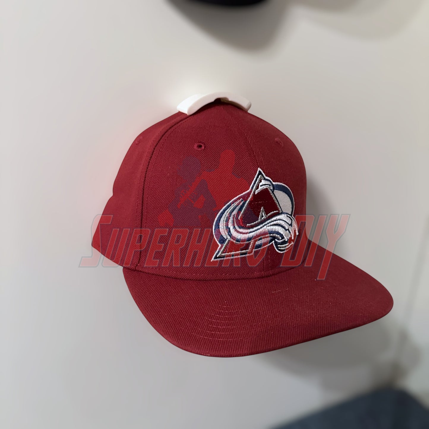 Hat on a wall using a hat display wall mount, showcasing easy organization for caps. Perfect dual function hat holder solution.