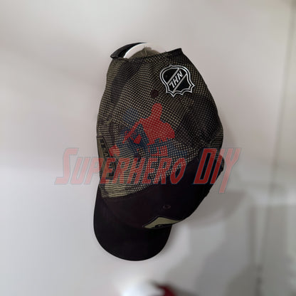 Black hat displayed on wall mount, featuring superhero design, highlighting effective hat display wall mount use