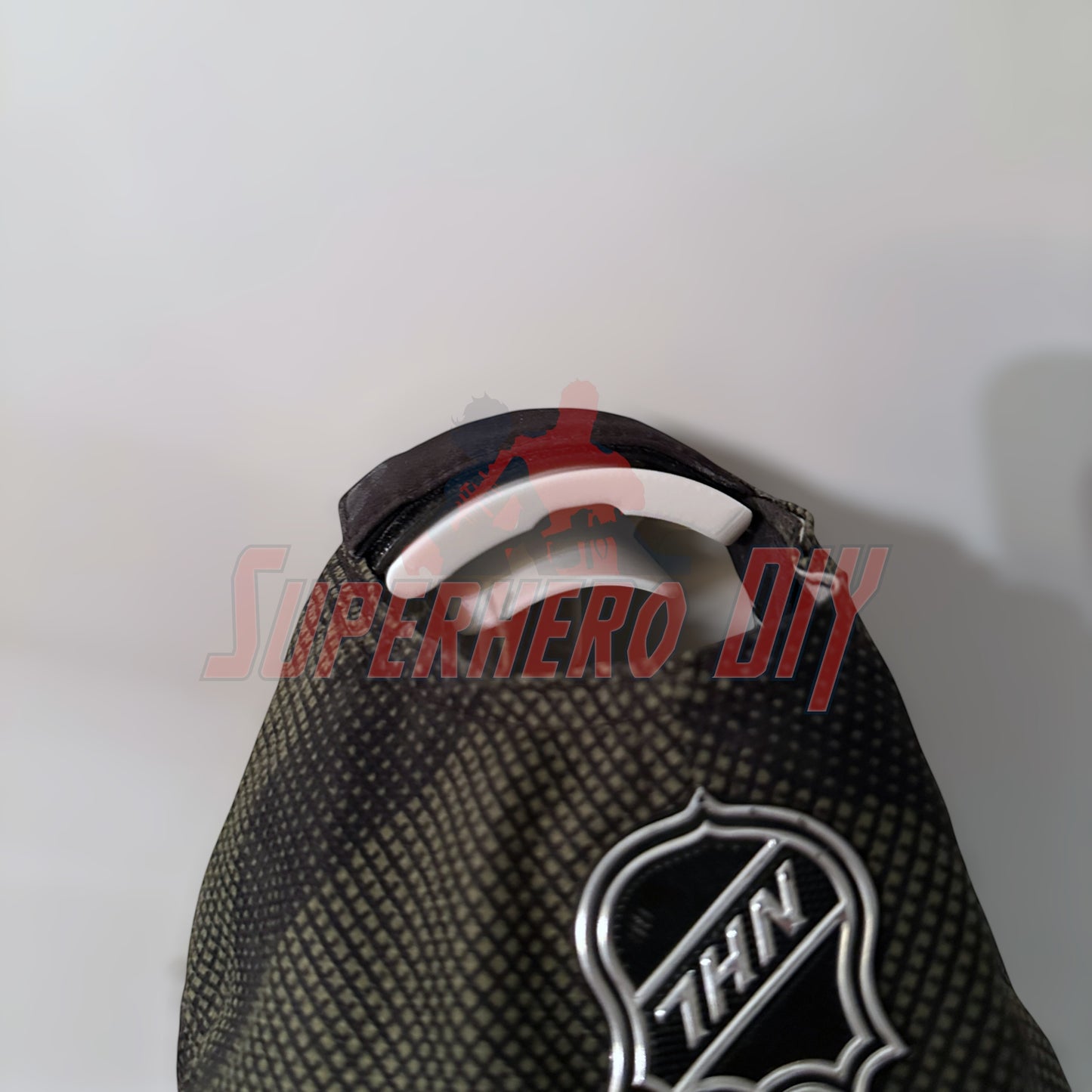 Close-up of a hat on a wall hook from a hat display wall mount.