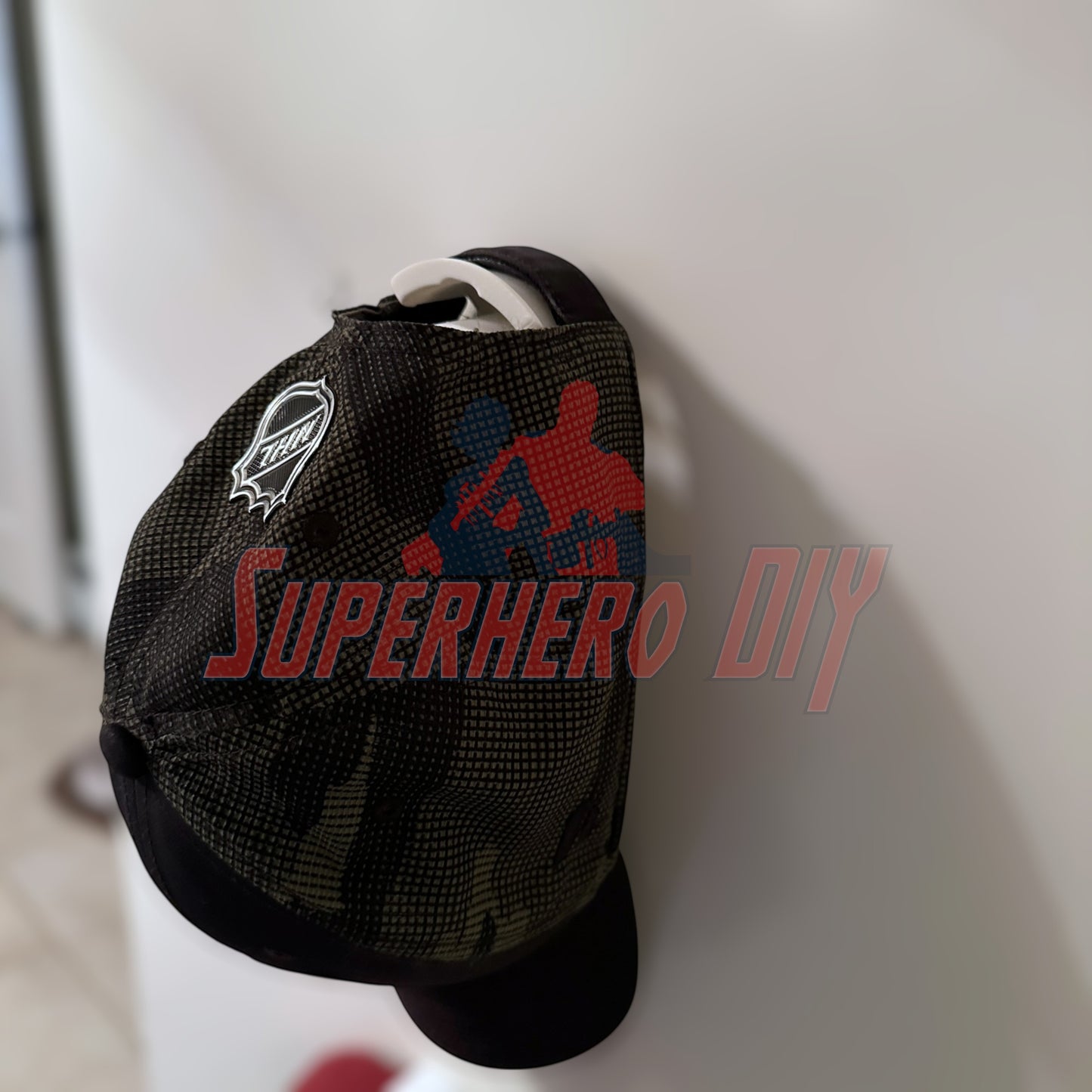 Wall-mounted hat display with Command Strip holding a cap securely, ideal for organizing and showcasing your collection in style.