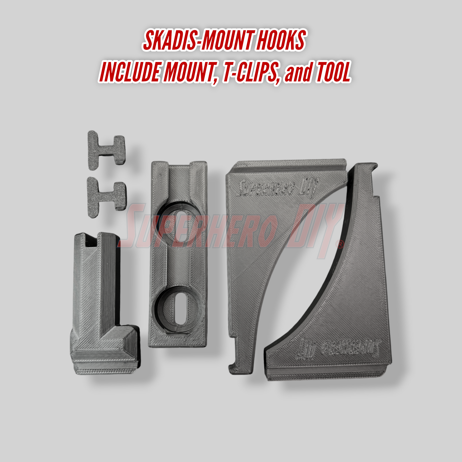 Skadis-mount hooks with mount, T-clips, and tool on a gray background