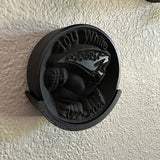 Detailed view of a 3D-printed hockey puck holder wall mount, showcasing a unique design and black finish.