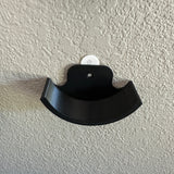 Hockey puck holder wall mount showcasing a sleek black design for displaying hockey pucks.