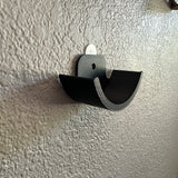 Hockey puck holder wall mount designed for displaying prized hockey pucks securely.