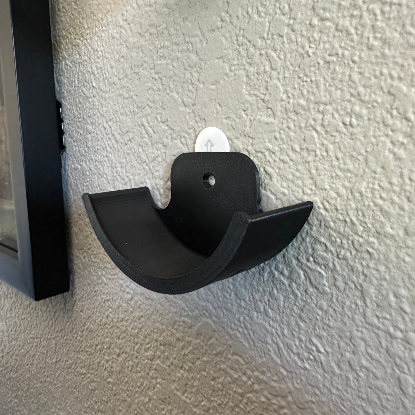 Hockey puck holder wall mount displayed on a textured wall, designed to showcase prized hockey pucks.