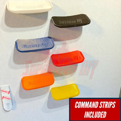 Colorful display shelf for Hot Wheels vehicles with Command strips included for easy installation on walls.