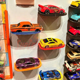 Display shelf for Hot Wheels featuring 1:64 scale diecast cars neatly arranged, showing the clutter-free floating design with command strip.