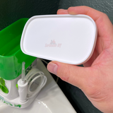 Lid for Waterpik Traveler Water Flosser WP-300 held in hand, covering the water tank to keep it clean.